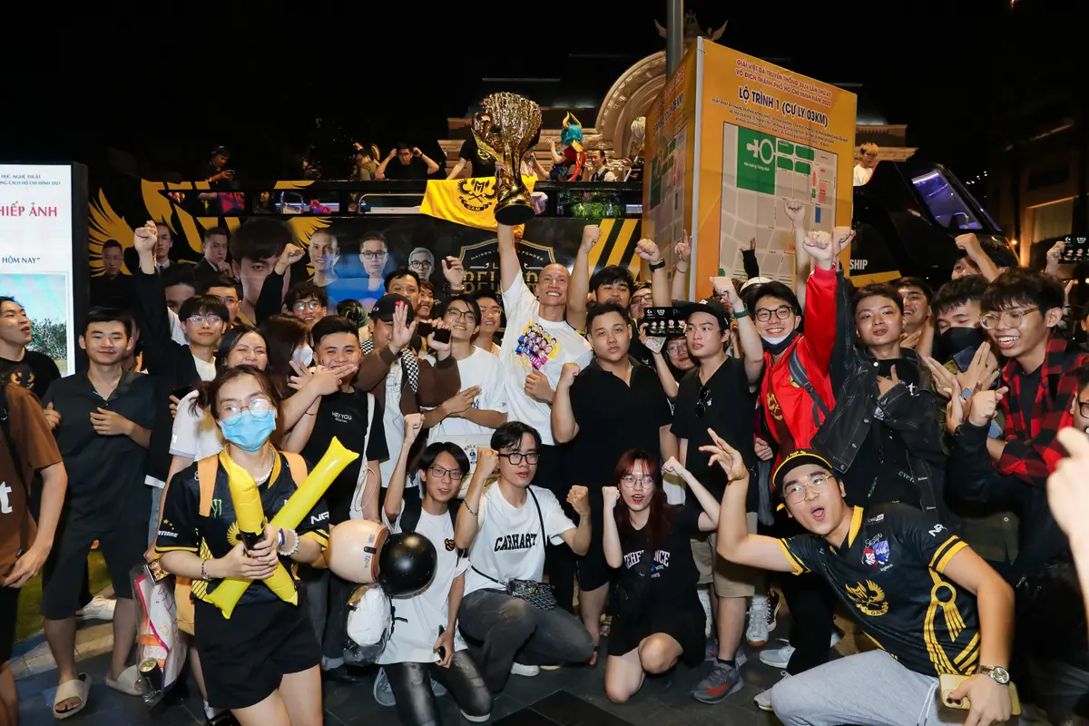 Fans lift the VCS trophy overhead at the victory parade