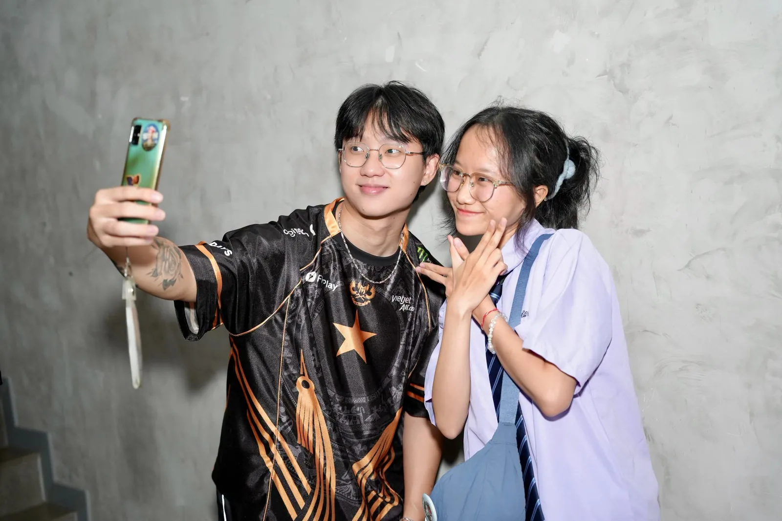 A GAM player takes a photo with a fan at the send-off
